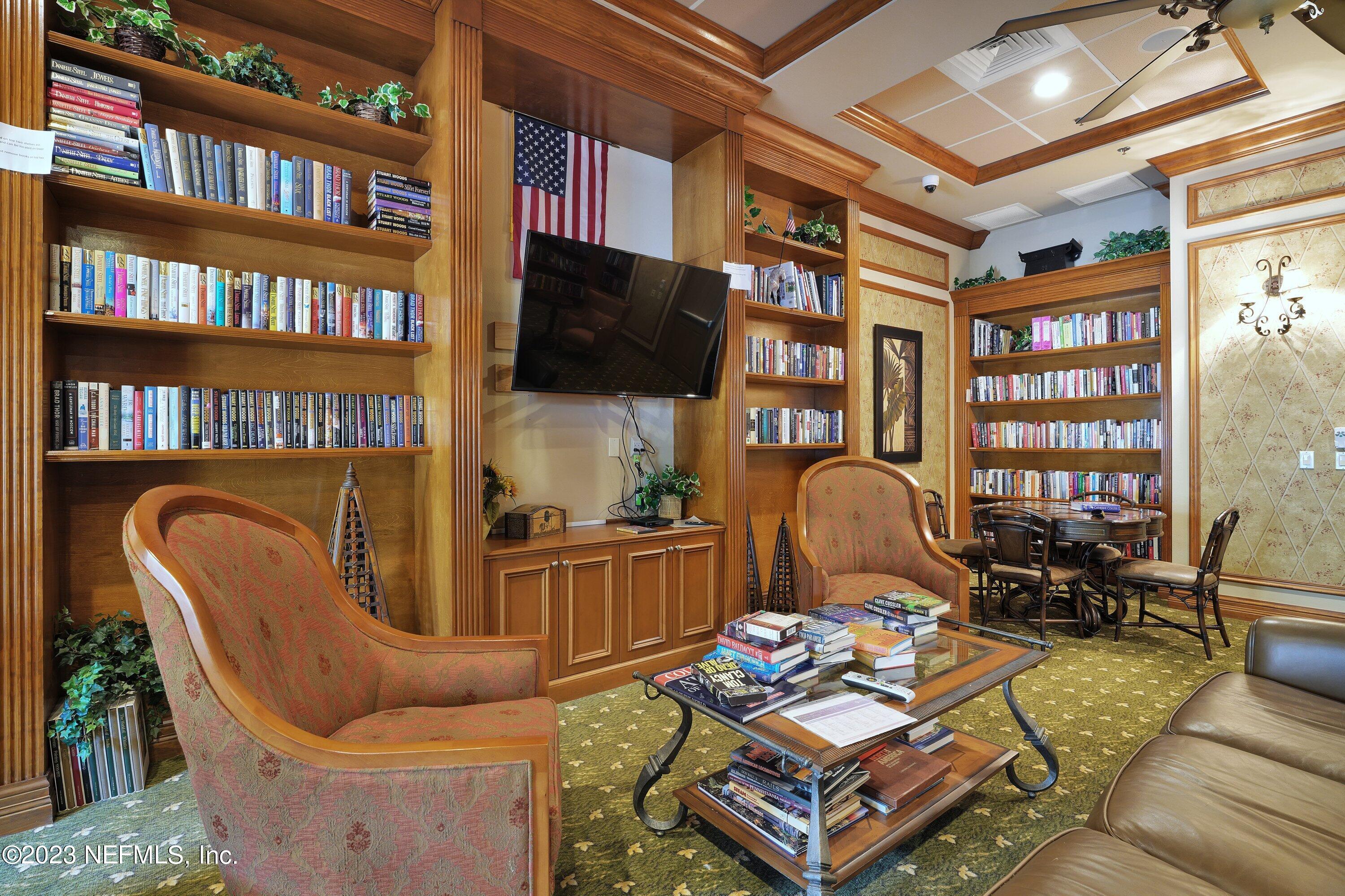 746 Copperhead Circle St. Augustine, FL 32092 - Photo 27 of 40 a living room with furniture a rug and a flat screen tv