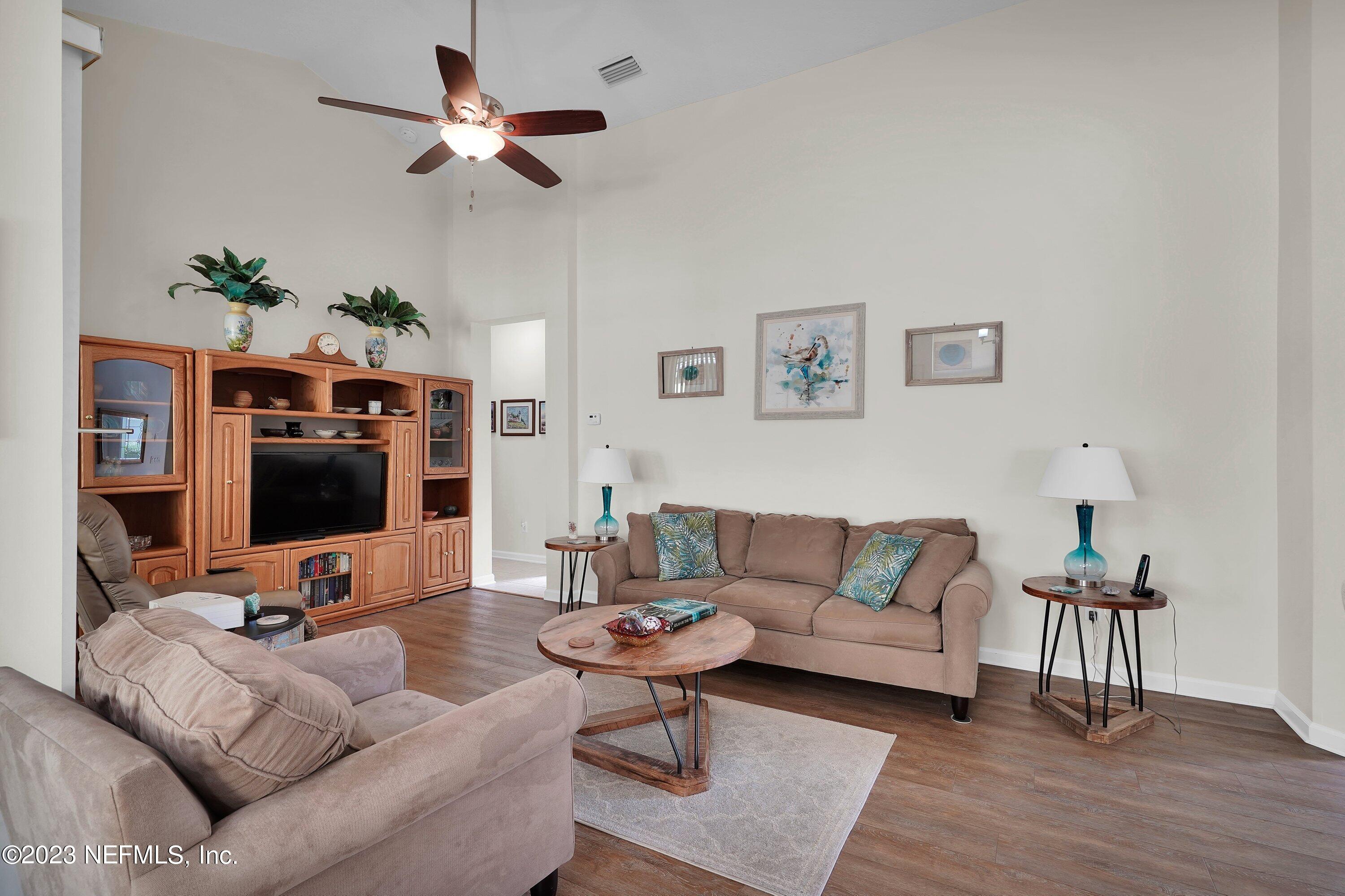 746 Copperhead Circle St. Augustine, FL 32092 - Photo 7 of 40 a living room with furniture and a flat screen tv