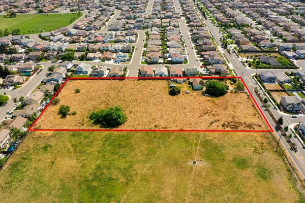 an aerial view of residential houses with yard