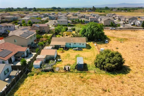 an aerial view of residential houses with outdoor space