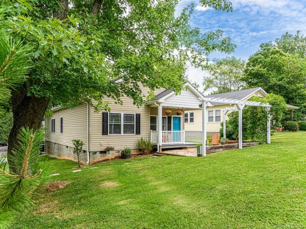 122 Round Top Road Asheville, NC 28803 - Photo 2 of 32 a front view of house with a garden and trees