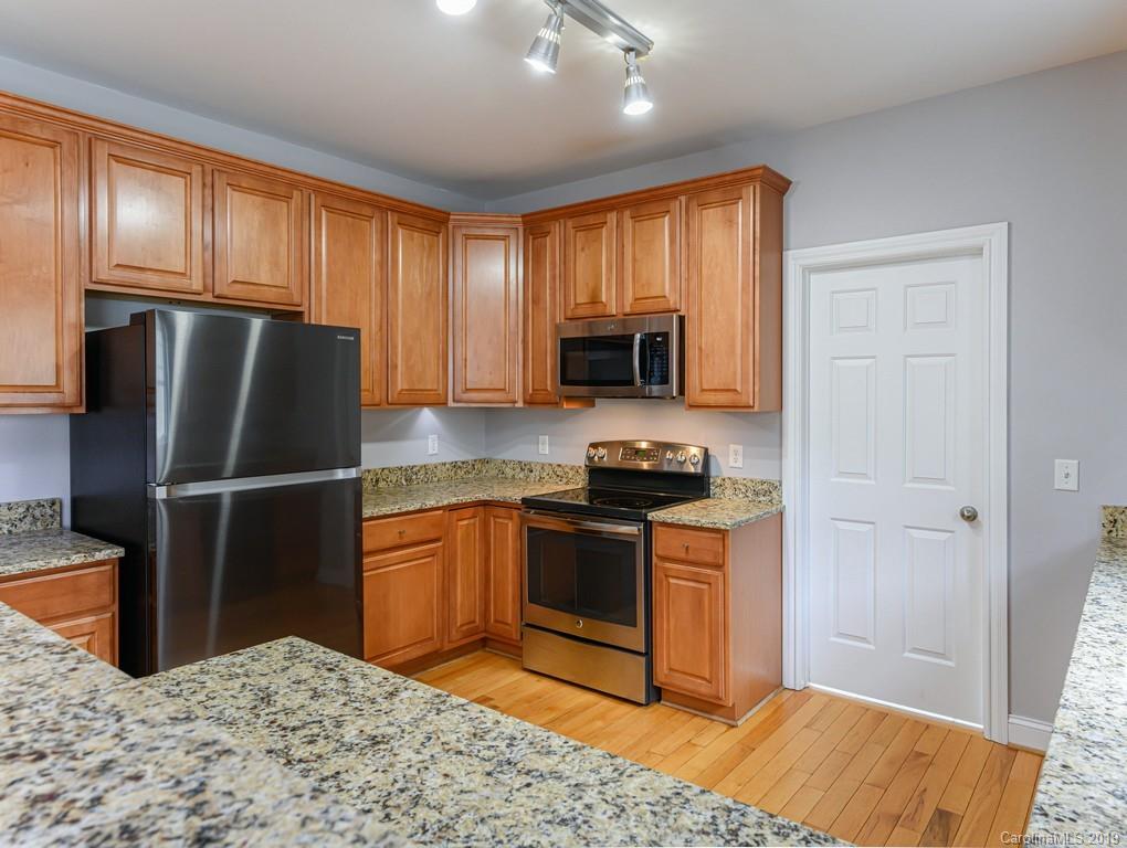 122 Round Top Road Asheville, NC 28803 - Photo 12 of 32 a kitchen with stainless steel appliances granite countertop a stove a refrigerator and a sink