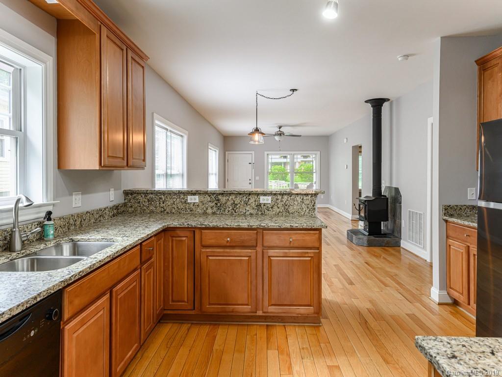 122 Round Top Road Asheville, NC 28803 - Photo 13 of 32 a kitchen with a sink and wooden floor