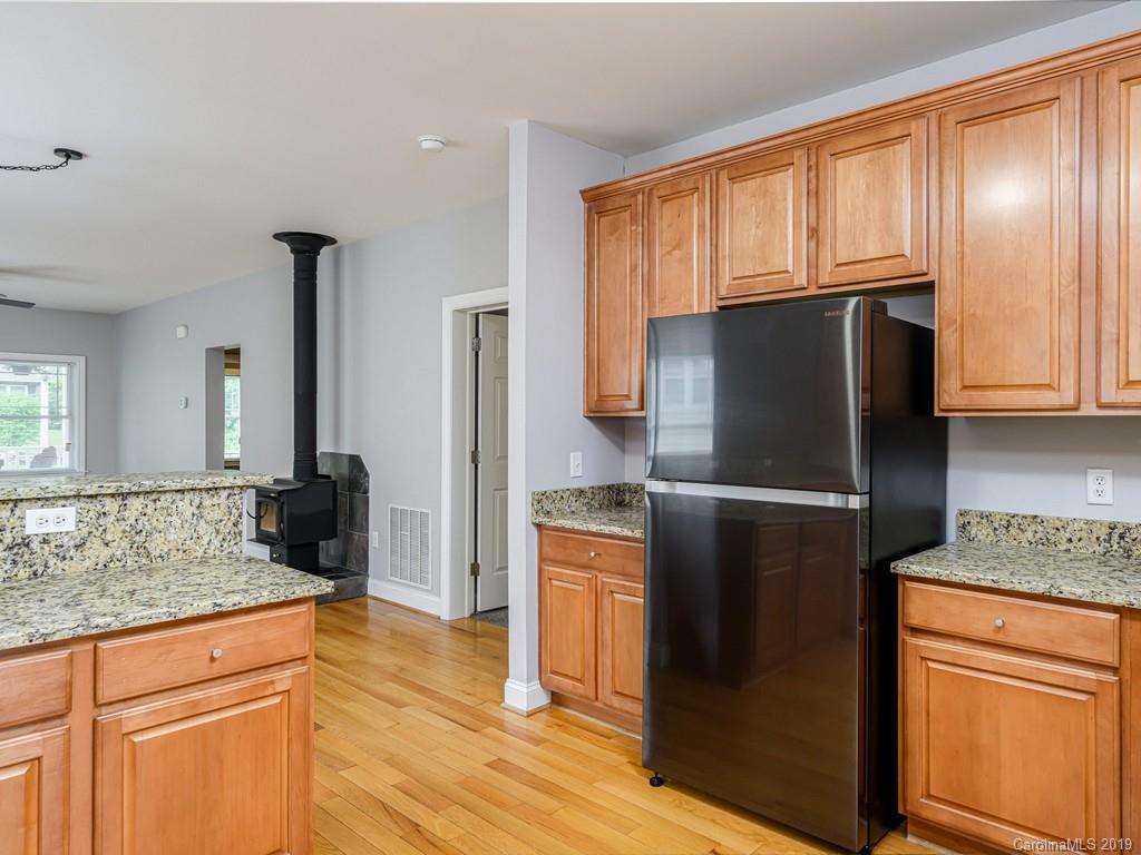 122 Round Top Road Asheville, NC 28803 - Photo 14 of 32 a kitchen with stainless steel appliances granite countertop a refrigerator and a stove top oven
