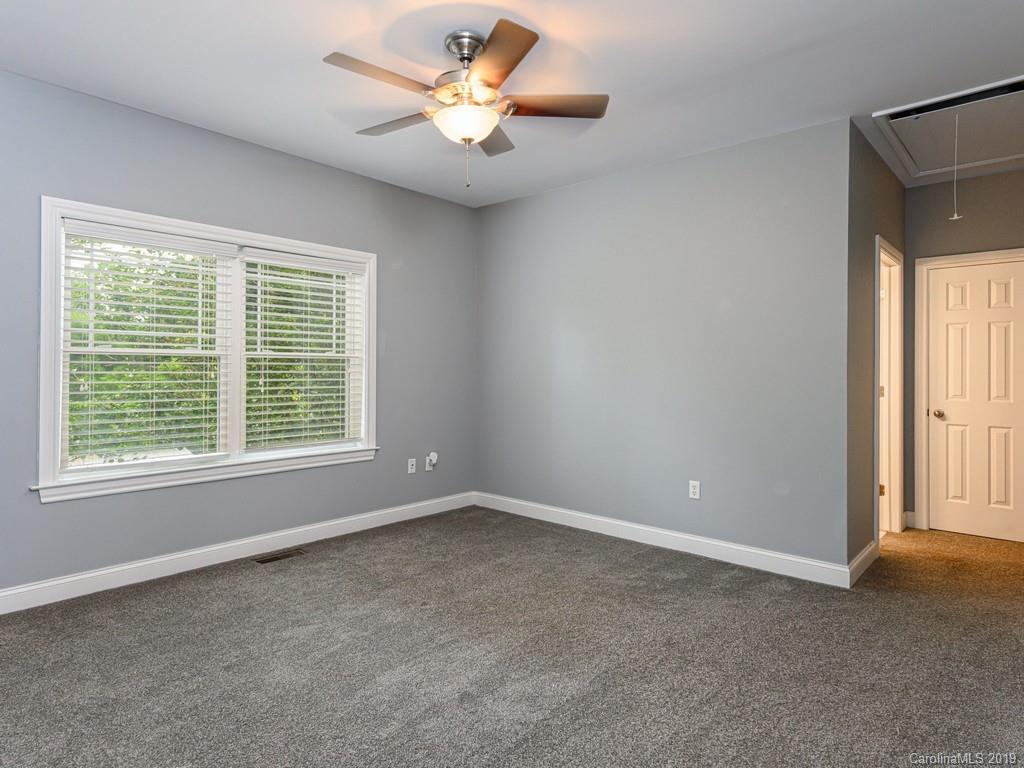 122 Round Top Road Asheville, NC 28803 - Photo 16 of 32 a view of an empty room with a window