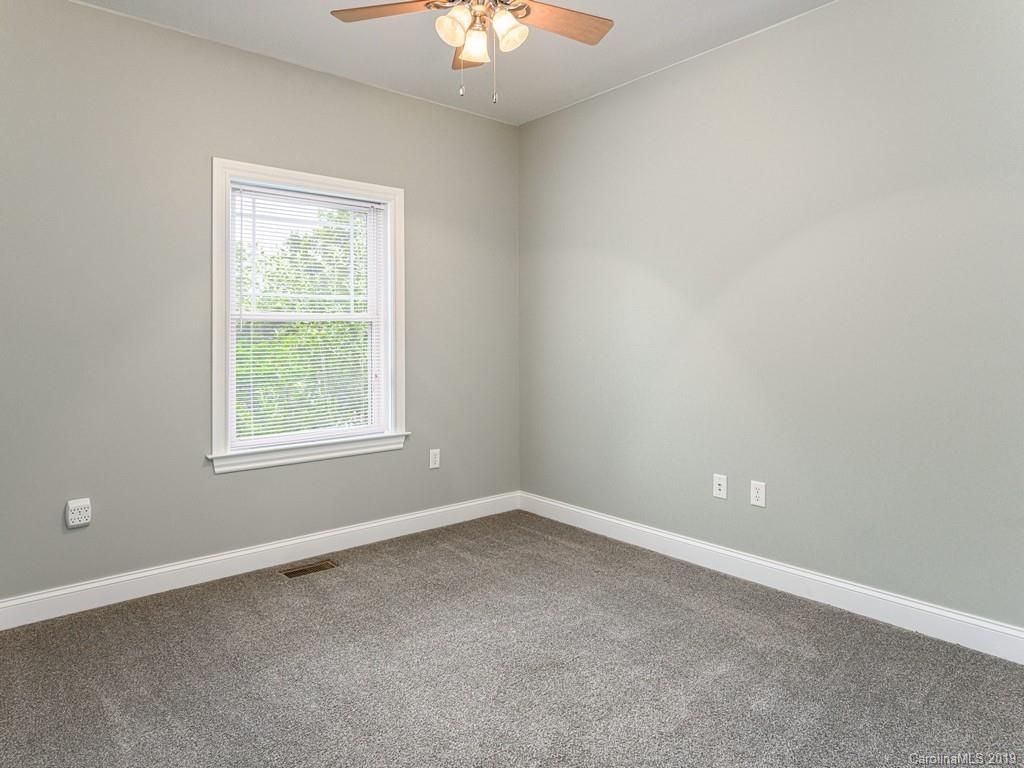 122 Round Top Road Asheville, NC 28803 - Photo 19 of 32 an empty room with a window