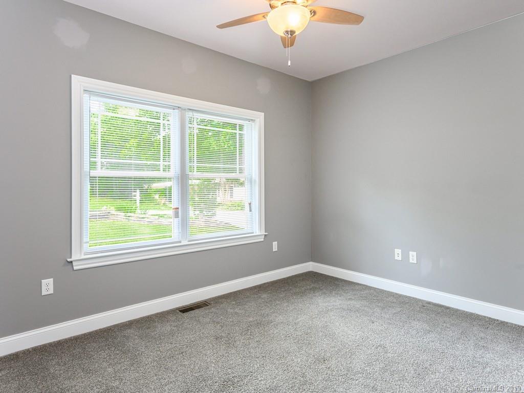 122 Round Top Road Asheville, NC 28803 - Photo 21 of 32 an empty room with a window