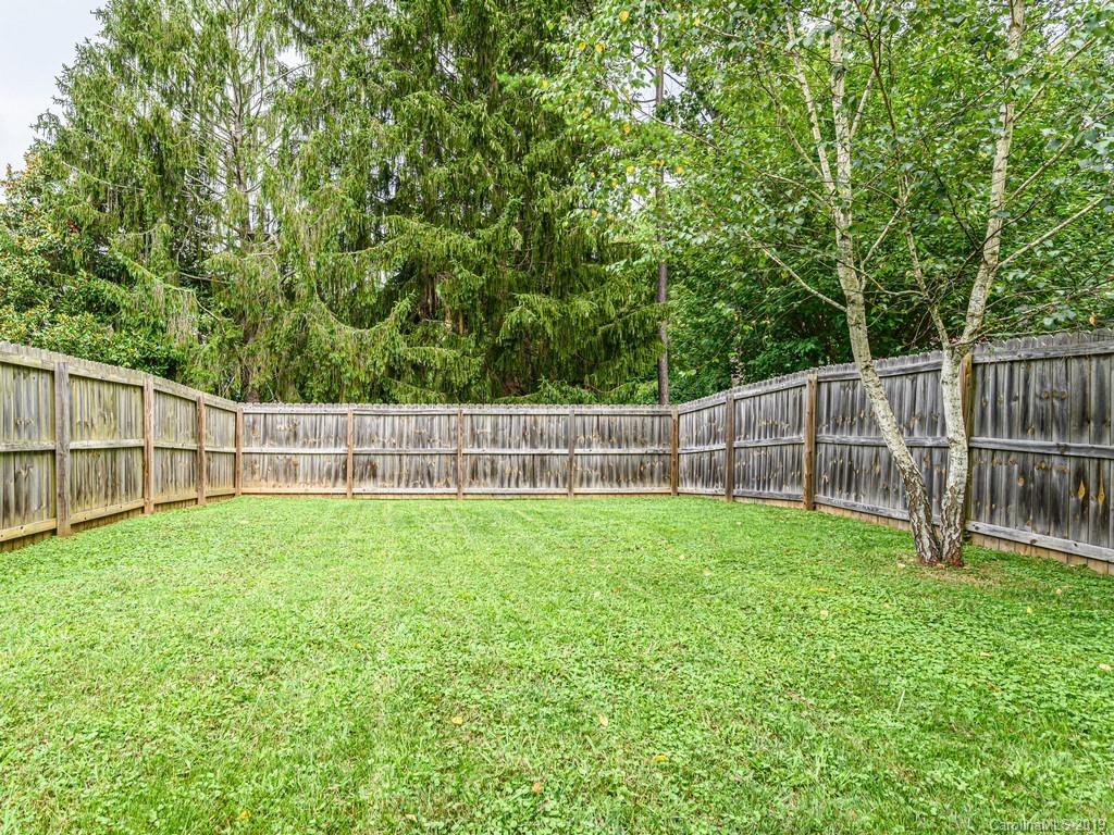 122 Round Top Road Asheville, NC 28803 - Photo 24 of 32 a view of a yard with a wooden fence