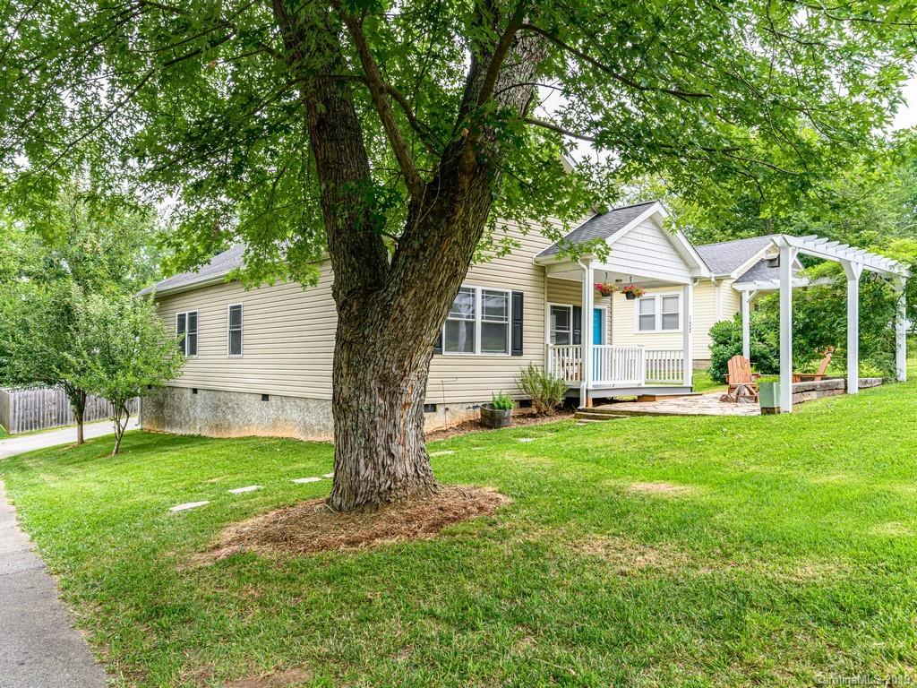 122 Round Top Road Asheville, NC 28803 - Photo 31 of 32 a front view of a house with a garden and trees