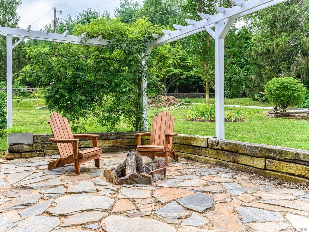 122 Round Top Road Asheville, NC 28803 - Photo 5 of 32 a view of a sitting area with chairs in backyard