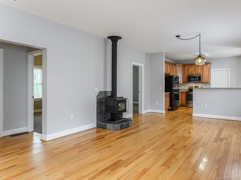 122 Round Top Road Asheville, NC 28803 - Photo 8 of 32 a view of kitchen with refrigerator stove and wooden floor
