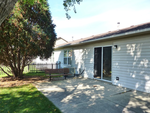 1820 77th Street Naperville, IL 60565 - Photo 15 of 18 a front view of a house with a garden