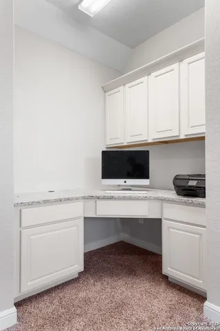 a kitchen with white cabinets and white appliances