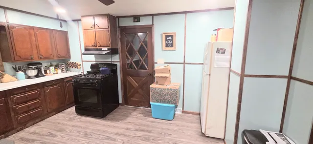 a kitchen with a refrigerator and a sink