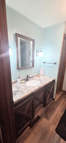 a bedroom with a bed and a mirror