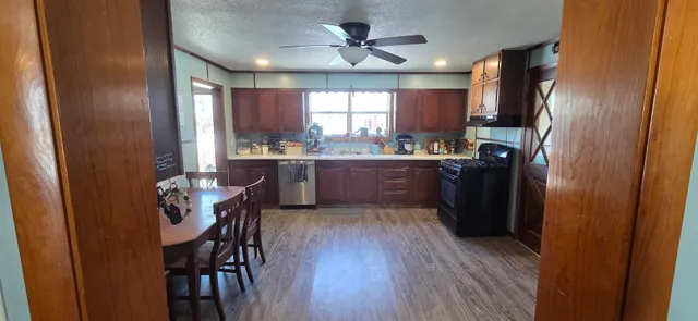 a kitchen with granite countertop cabinets stainless steel appliances and a window