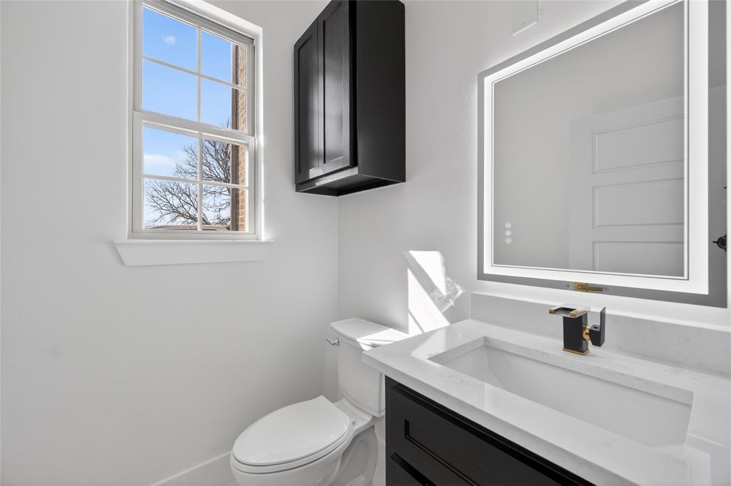 1530 South Houston School Road Lancaster, TX 75146 - Photo 11 of 37 a bathroom with a granite countertop sink toilet and mirror
