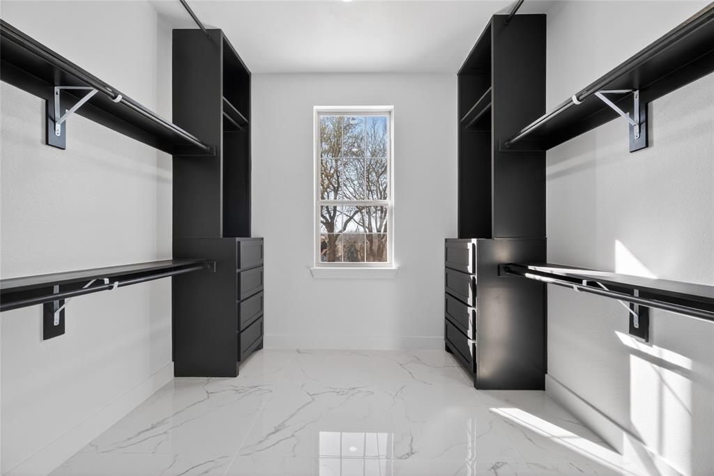 1530 South Houston School Road Lancaster, TX 75146 - Photo 22 of 37 a view of walk in closet with clothes and shoes