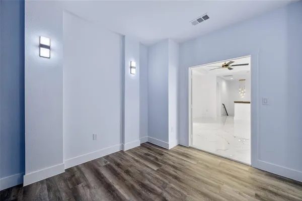 a view of an empty room with a ceiling fan