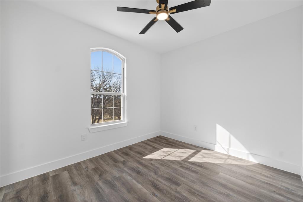 1530 South Houston School Road Lancaster, TX 75146 - Photo 30 of 37 a view of empty room with wooden floor and fan
