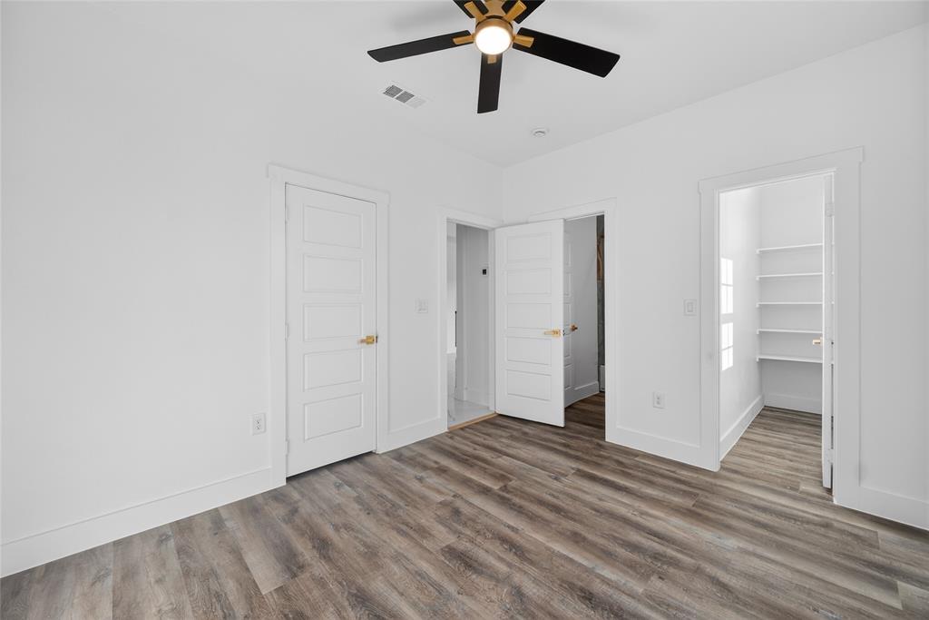 1530 South Houston School Road Lancaster, TX 75146 - Photo 31 of 37 a view of a room with wooden floor and ceiling fan