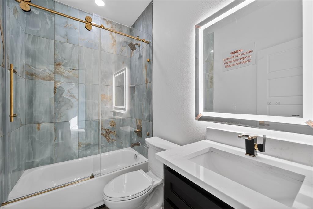 1530 South Houston School Road Lancaster, TX 75146 - Photo 32 of 37 a bathroom with a sink toilet and shower