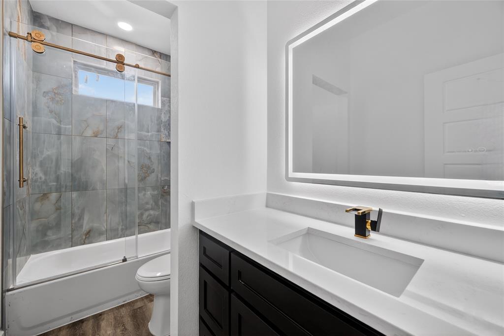 1530 South Houston School Road Lancaster, TX 75146 - Photo 34 of 37 a bathroom with a sink a toilet and shower