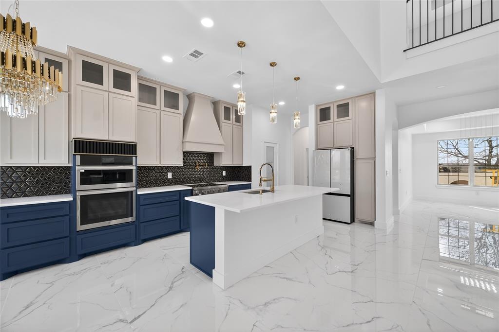 1530 South Houston School Road Lancaster, TX 75146 - Photo 8 of 37 a large white kitchen with stainless steel appliances granite countertop a stove and a refrigerator