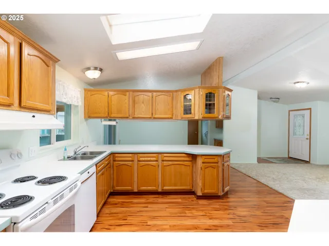 a kitchen with stainless steel appliances granite countertop a sink and a stove
