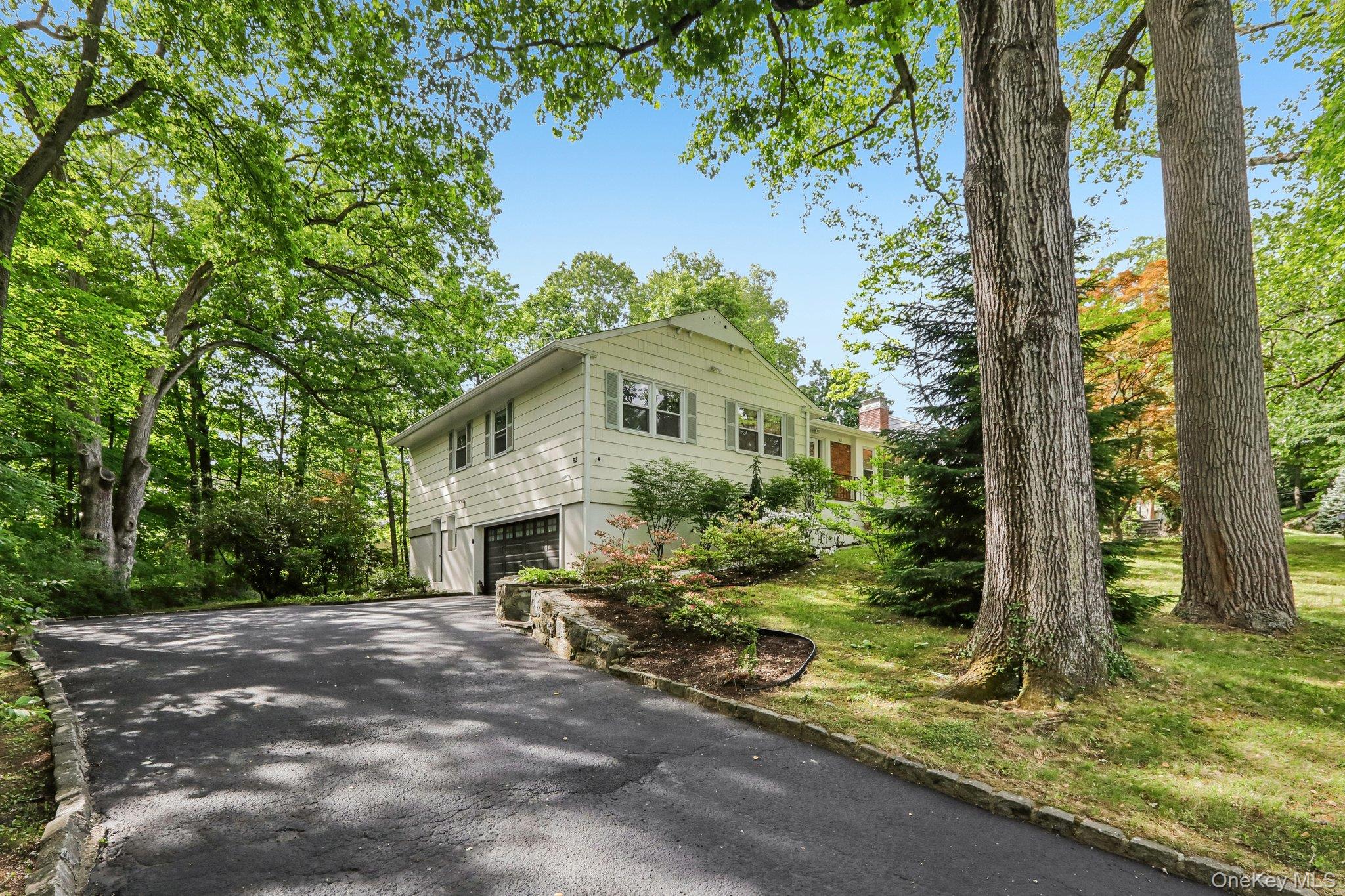 62 Mohegan Road Larchmont, NY 10538 - Photo 2 of 46 a front view of a house with a yard