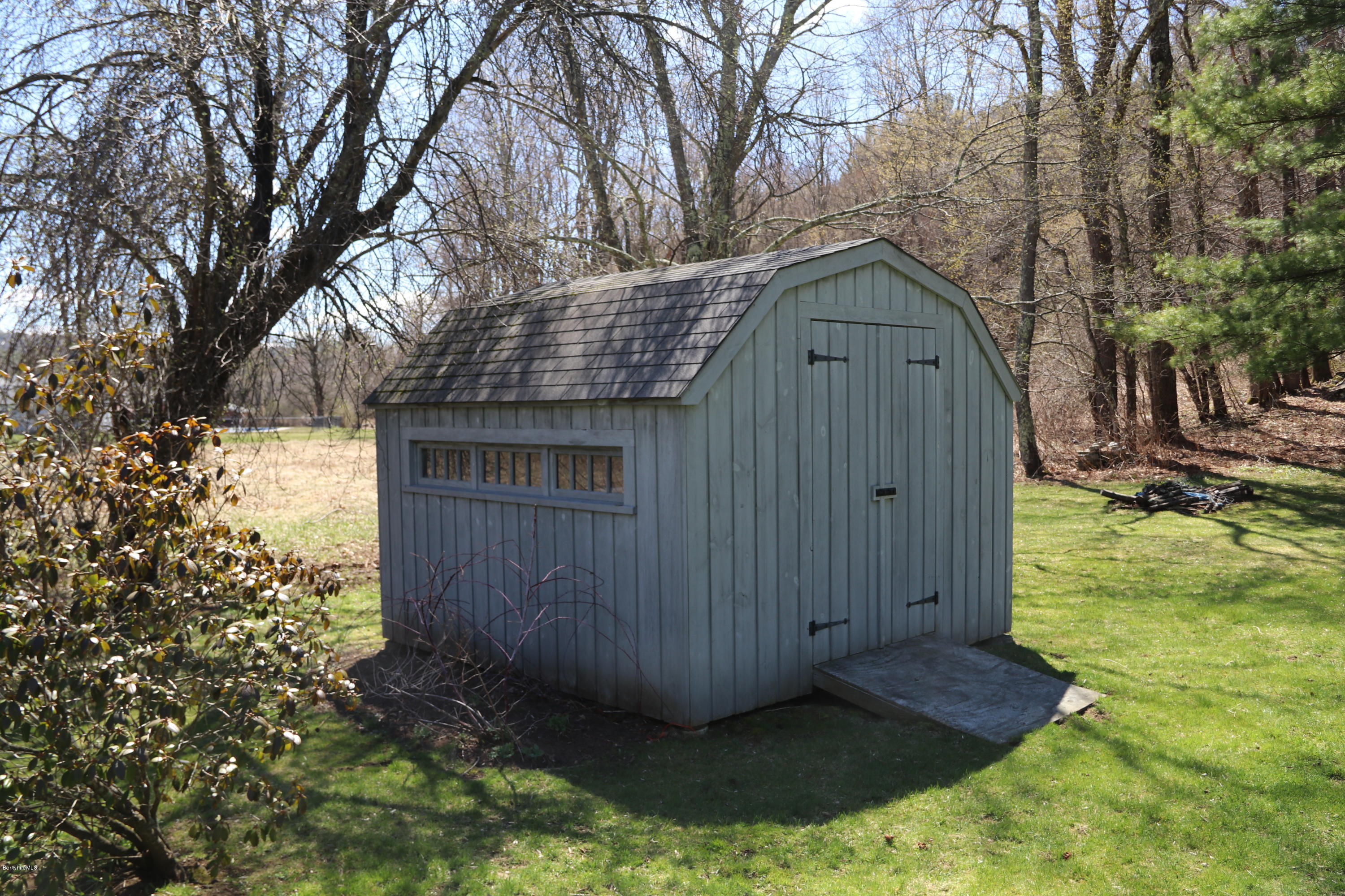 49 Sandisfield Road Sandisfield, MA 01255 - Photo 7 of 23 a view of wooden house with a small yard and large trees