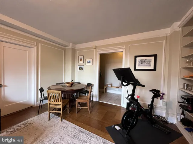 a view of a room that has a table and chairs in it