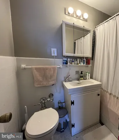 a bathroom with a sink a toilet and a mirror
