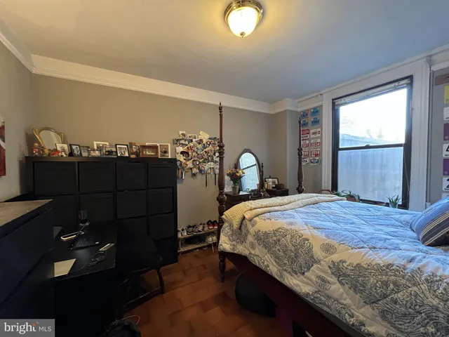 a bedroom with a bed and a dresser