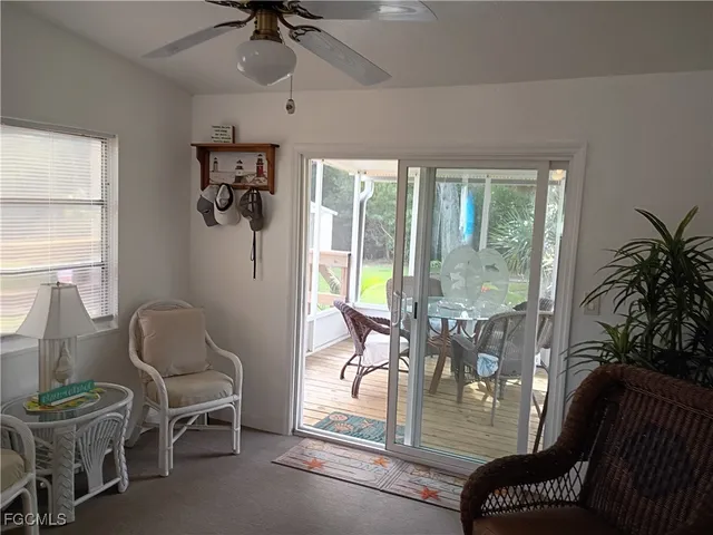 a dining room with furniture water view and a floor to ceiling window