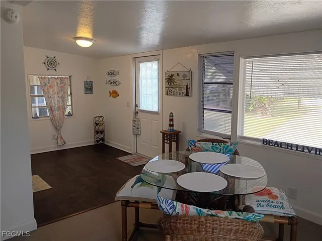 a dining room with furniture and wooden floor