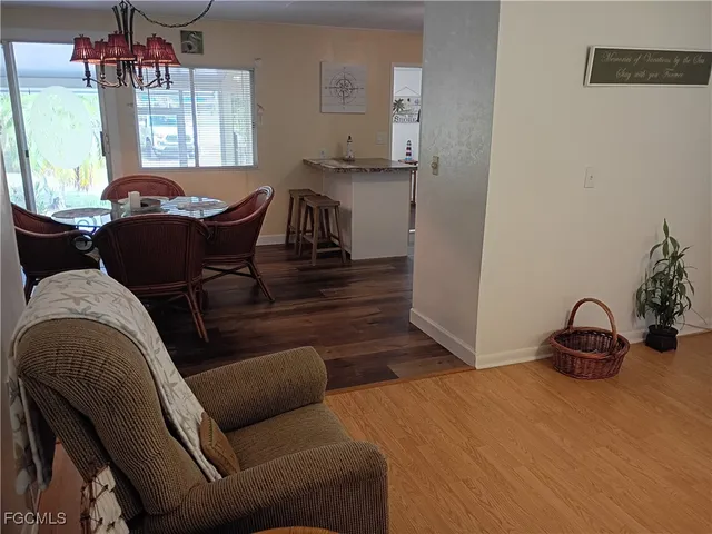 a living room with furniture a window and a potted plant