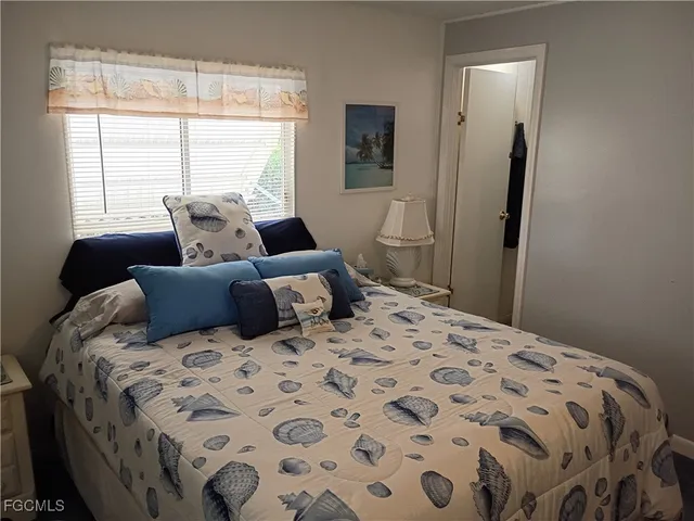 a bedroom with a large bed and a window