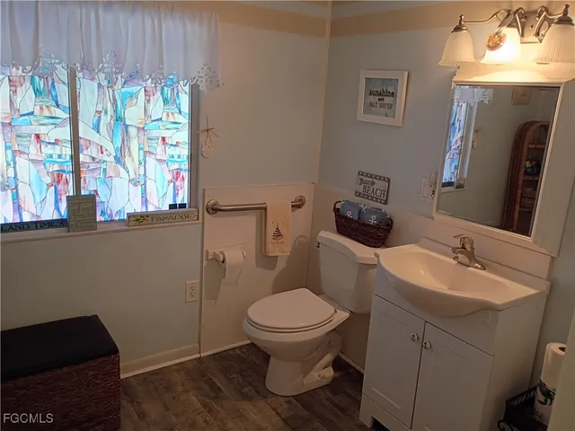 a bathroom with a toilet sink and mirror