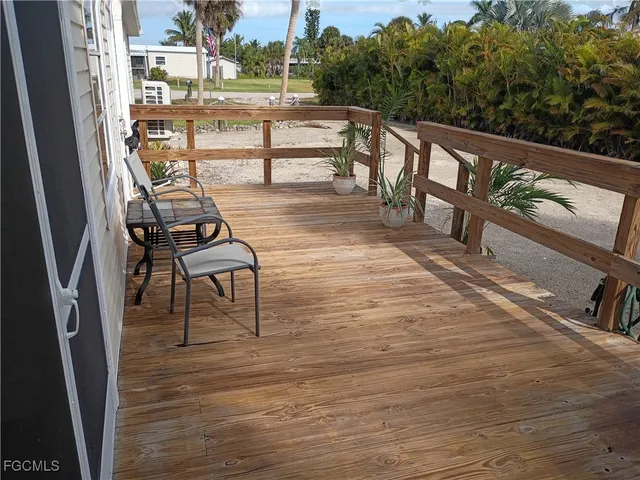 a view of balcony with wooden floor and outdoor seating