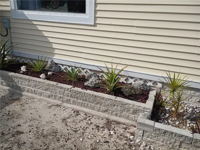 a view of a swimming pool with a yard and palm trees