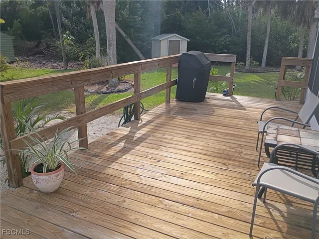 a view of a deck with wooden floor and seating space
