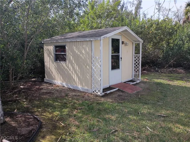 a view of a small house with a yard
