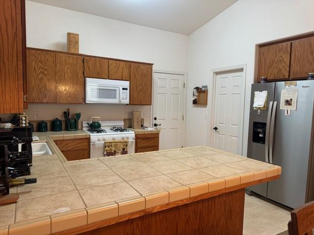 30639 Kit Fox Court Visalia, CA 93291 - Photo 6 of 16 a kitchen with stainless steel appliances kitchen island granite countertop a refrigerator and a stove top oven