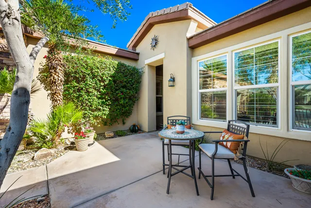 a building outdoor space with patio furniture and potted plants