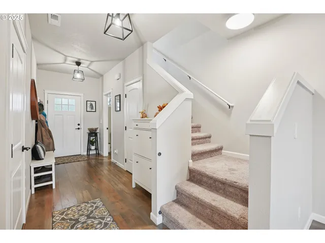 a view of entryway and hall with wooden floor