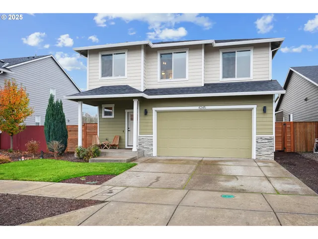 a front view of a house with a yard and garage