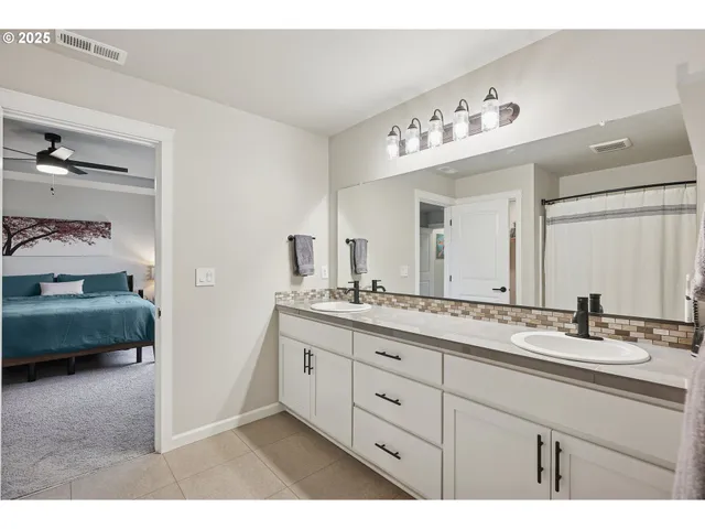 a bathroom with a sink double vanity and a mirror