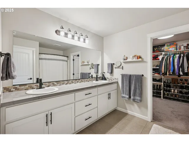 a bathroom with a double vanity sink and a mirror
