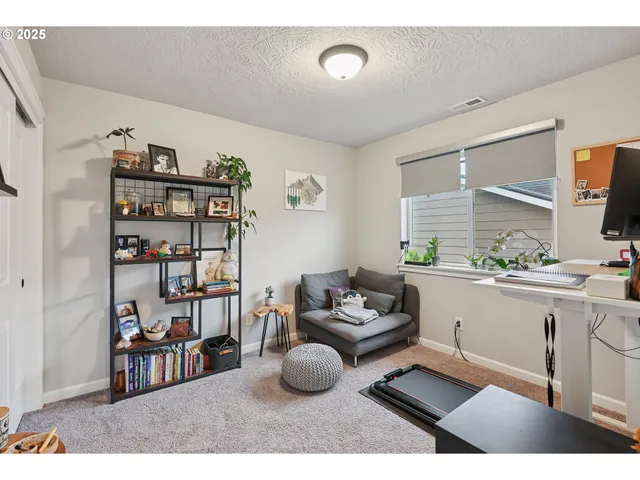 a living room with furniture and a book shelf